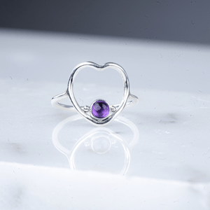 Heart amethyst ring laying down.