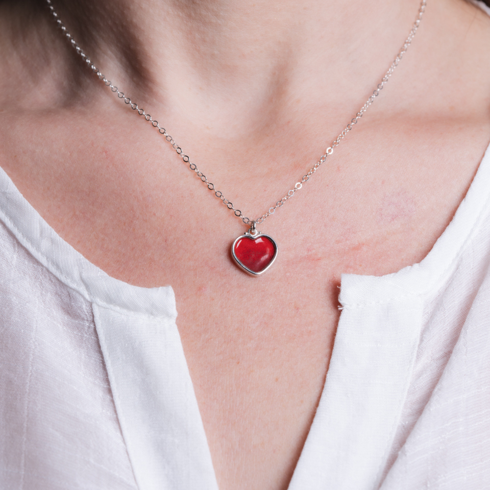 Heart enamel solid red necklace on model in silver.