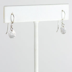 Silver mini disc earrings on T stand.