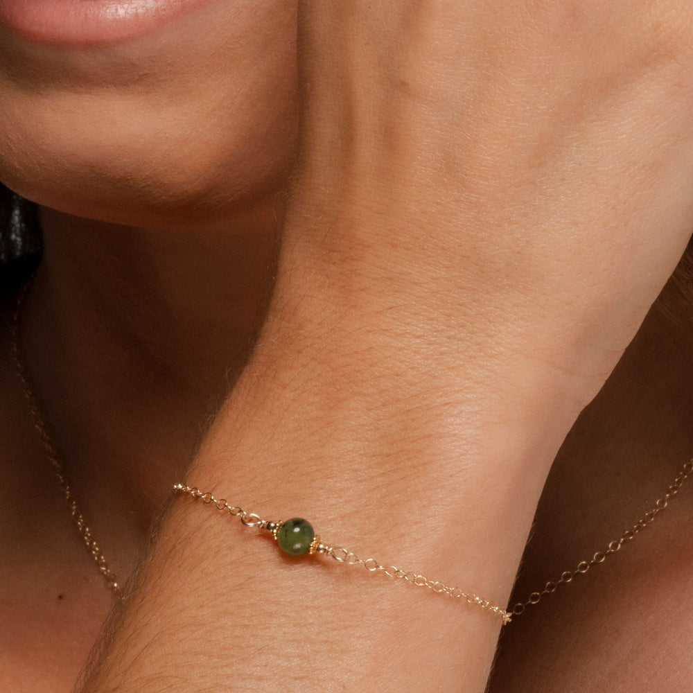 
                
                    Load image into Gallery viewer, Alora Bracelet with Jade on 14k Gold Fill medium shot on model.
                
            