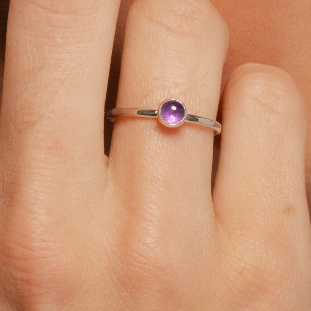 Facet Ring in closeup on model hand with amethyst.