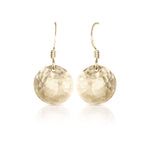 Gold convex textured earrings.
