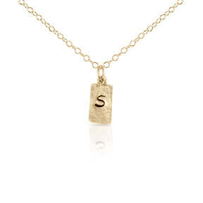 Gold rectangle initial necklace.