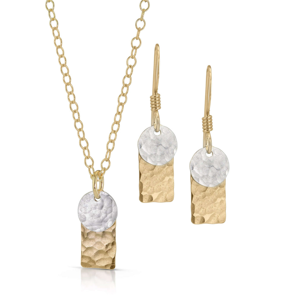 Gold rectangle and silver disc jewelry set.