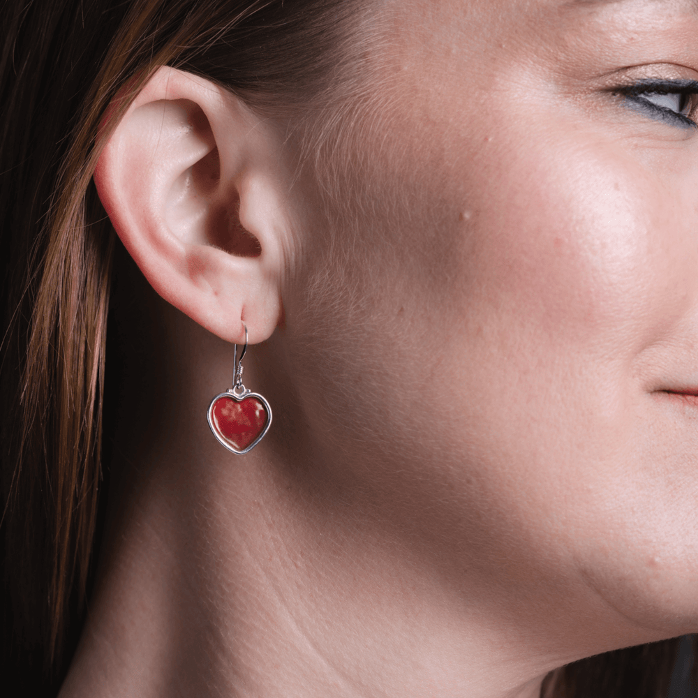 
                
                    Load image into Gallery viewer, Heart enamel solid red earrings on model.
                
            