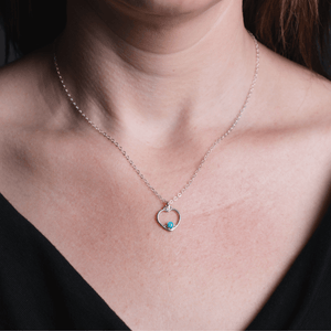 
                
                    Load image into Gallery viewer, Heart turquoise necklace on silver on model.
                
            