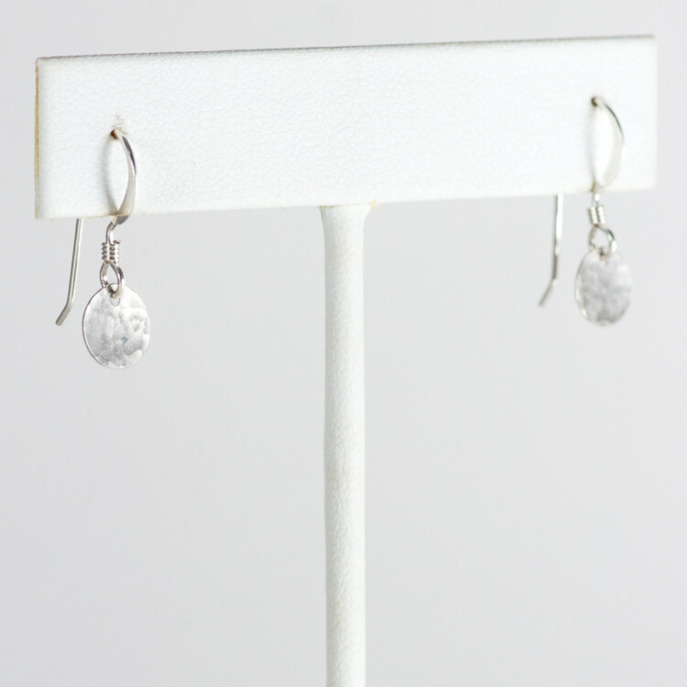 Silver mini disc earrings on T stand.