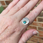 Starburst ring with round top with turquoise on hand model.