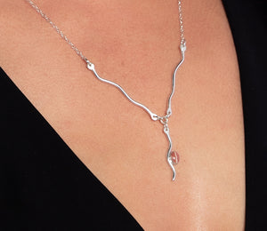 Wave rhodochrosite necklace closeup on model.